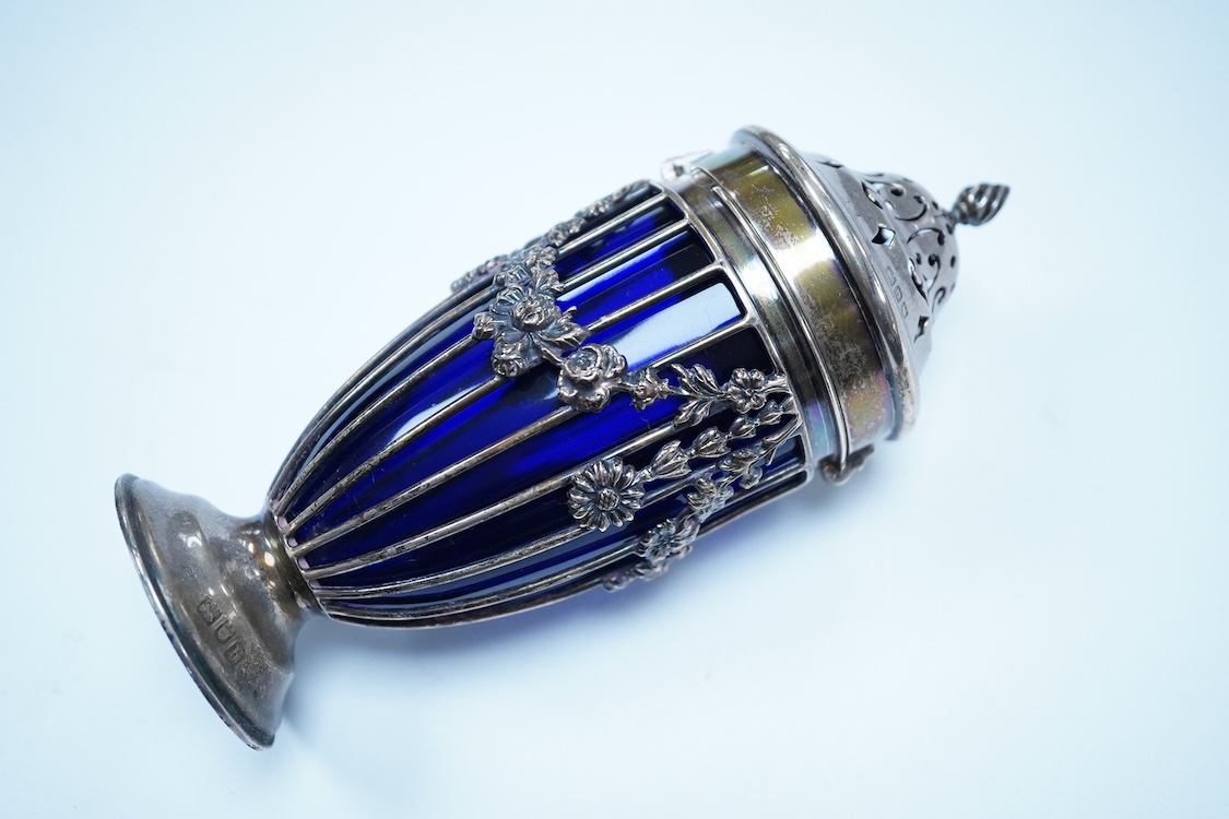 An Edwardian pierced silver sugar caster, with blue glass liner, Haseler Brothers, London, 1903, height 14.3cm.